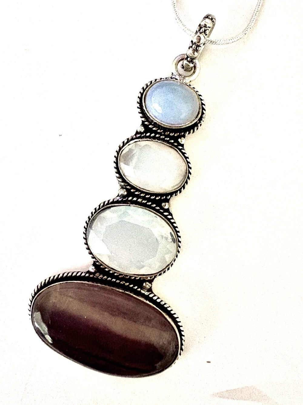 3 inch , 925 marked,, Fluorite stone on the bottom and 3 Opalite on the top.